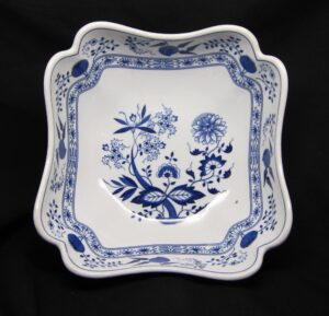 Square ceramic vegetable bowl with a scalloped rim and blue floral pattern on white, shown from above.