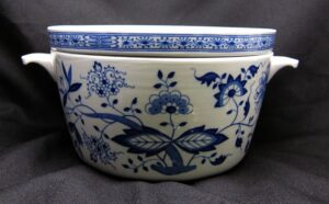 Ceramic soup pot with two side handles and a blue floral pattern on a white background.