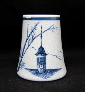 Ceramic shaker with a blue-and-white clock tower and tree illustration.