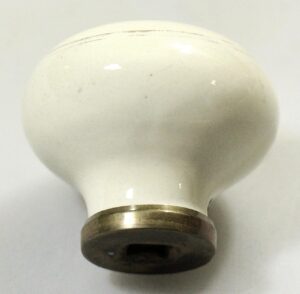 White porcelain door knob with a metal base, shown in close-up from the front.