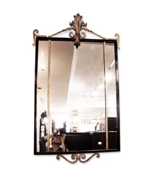 Vintage French wall mirror with a black rectangular frame and gold fleur-de-lis scrollwork at the top and bottom.