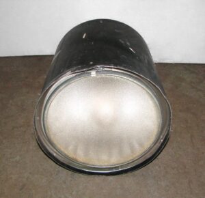 Industrial cylinder light with a pebbled Fresnel lens shown from the front.