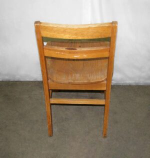 Back view of a classic wooden chair with a simple ladder back design and medium wood tone finish.