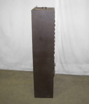 Tall narrow brown metal cabinet shown in a front view, with a row of drawer edges visible along one side.