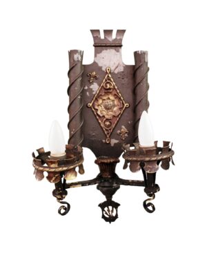 Pair of Tudor-style wall sconce pair with two candle-style arms, ornate detailing, and an antique bronze and black finish.