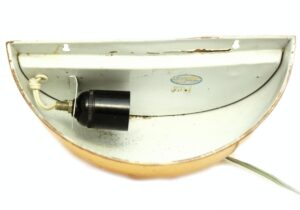 Interior dome wall sconce shown from the back, with visible wiring and bulb socket mounted inside the copper-finished brass shade.