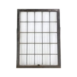 Large leaded glass window with an intact multi-pane grid in a weathered wooden frame.