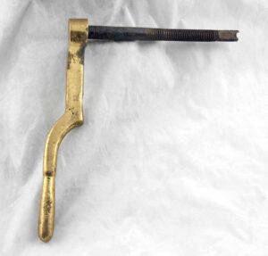 Polished brass door lever shown in profile with a threaded mounting stem.