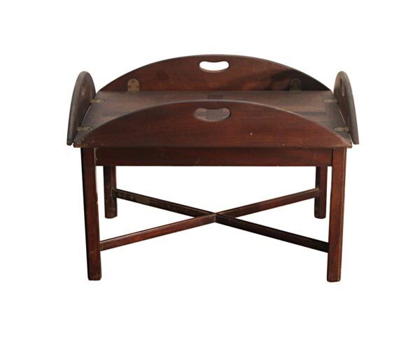 Traditional wooden butler’s side table with flip-up sides, handles, and crossed support stretchers.