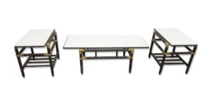 Three-piece table set with a coffee table in the center and two end tables, each with a white Formica top and dark wood base.