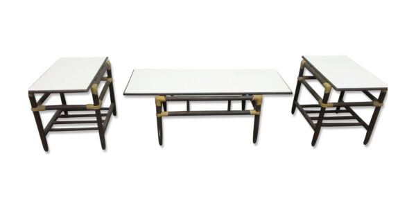 Three-piece table set with a coffee table in the center and two end tables, each with a white Formica top and dark wood base.