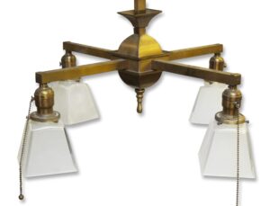 Traditional four-arm brass chandelier with square frosted glass down shades and pull chains.