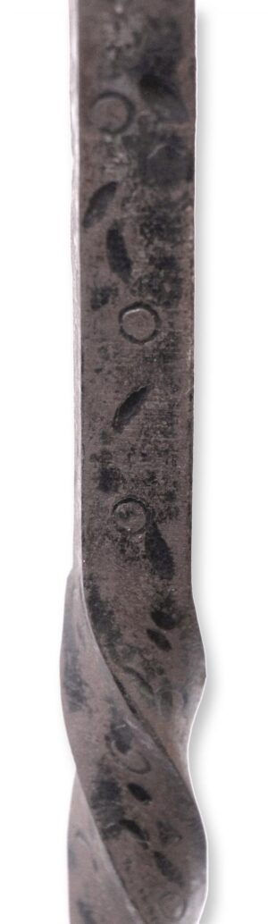 Close-up of a wrought iron fireplace tool with a twisted shaft and curled detail, shown as a single piece from the set.