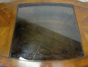 Oval oak coffee table with a glass center panel and caned lower shelf seen from above.