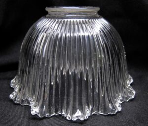 Clear ribbed glass pendant light globe with a fluted edge and narrow fitter opening shown from the side view.