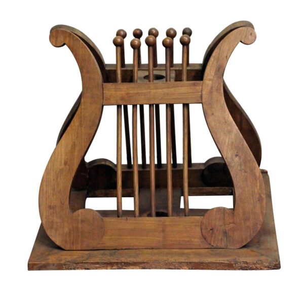 Carved wooden music or book stand with a medium wood tone and decorative curved side panels.