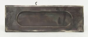 Polished bronze brass mail slot shown front on with a long rounded opening and visible mounting hook above.