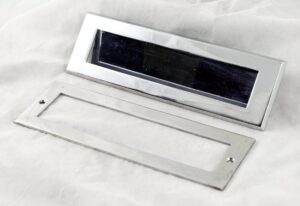 Stainless steel door letter slot with a matching interior plate shown side by side.
