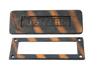 Vintage cast iron door mail slot set with a rectangular opening plate and matching lettered faceplate, shown in a black and copper finish.