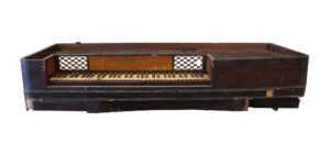 Antique piano forte keyboard in dark wood tone, shown open to reveal the keys and interior string area.