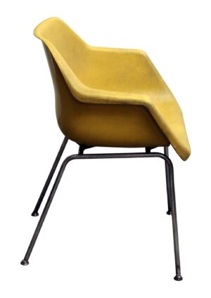Yellow molded plastic chair with a chrome frame, shown in side view.