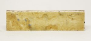 Single yellow crackled ceramic tile with a shiny glaze and minor age-related chips.