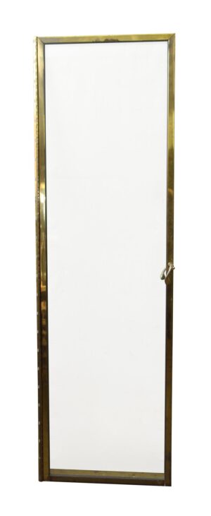 Brass framed clear glass shower door with a lever handle shown in full length.