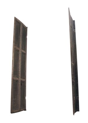 Pair of steel bi-fold shutters shown open, with six-panel cast iron details on one side and the latch hardware visible on the edge view of the other.