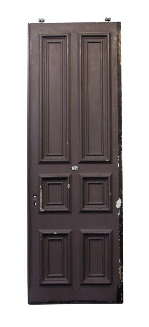 Six-panel pine pocket door with thick molding and a worn brown painted finish, shown front on with the hardware opening and house number 103 visible.