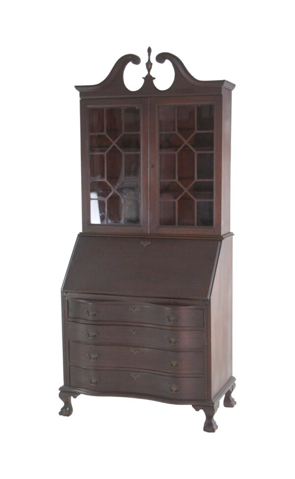 Dark wood writing desk with two glass-front cabinet doors, a slanted writing surface, and four drawers below.