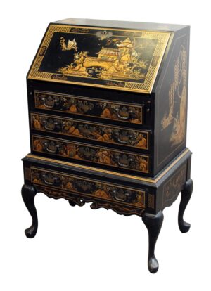 Oriental black and gold wood desk with a slanted top, three drawers, and curved legs, shown front view with decorative Eastern-style panels.