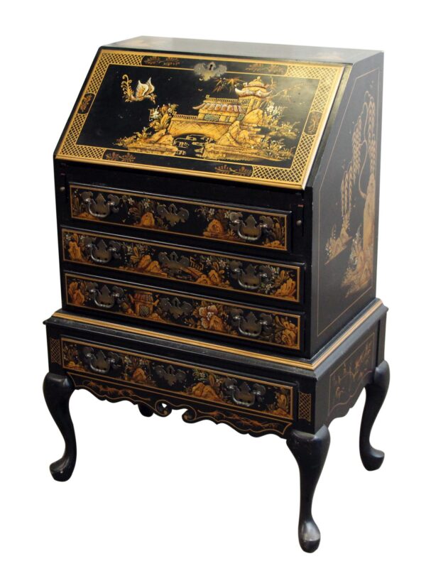 Oriental black and gold wood desk with a slanted top, three drawers, and curved legs, shown front view with decorative Eastern-style panels.