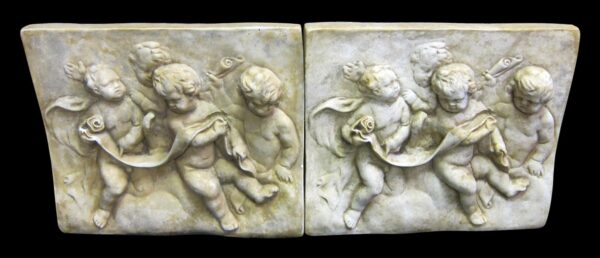 Pair of tan composite cherub relief panels, shown side by side with four figures in raised detail.