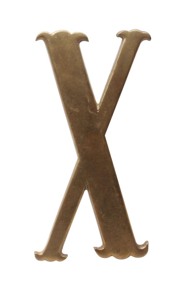 Solid brass letter X with a polished finish and four prongs on the back.