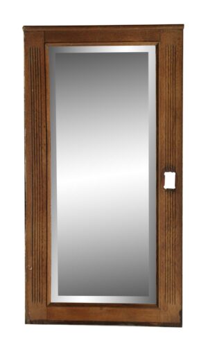 Vertical oak mirror with fluted side detail and a cutout for electrical on the right side.