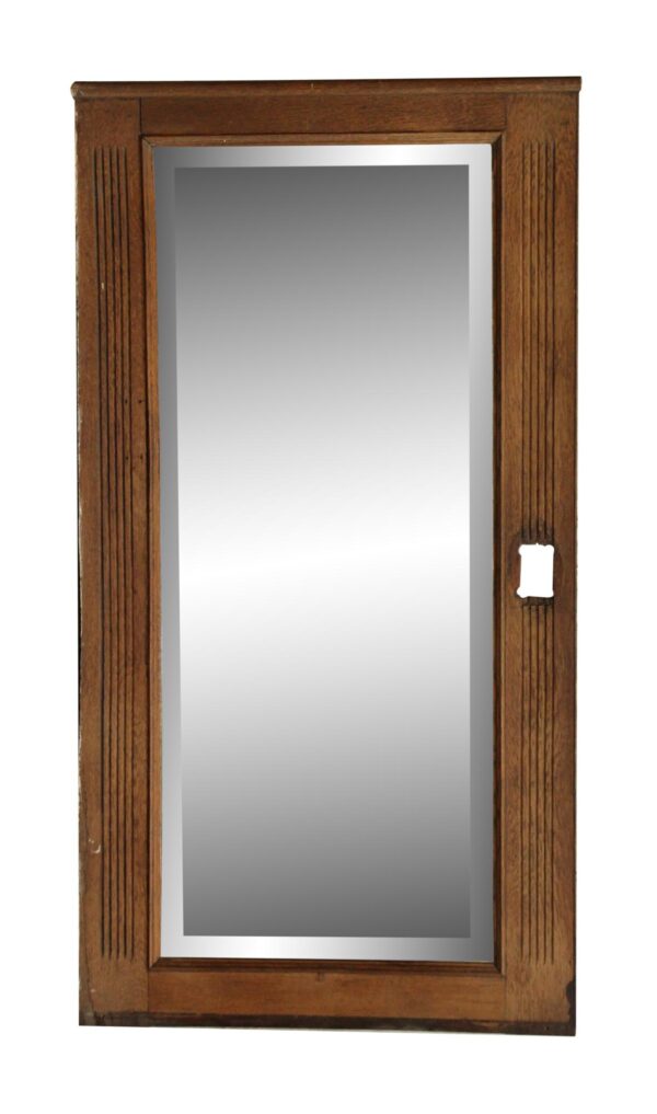 Vertical oak mirror with fluted side detail and a cutout for electrical on the right side.