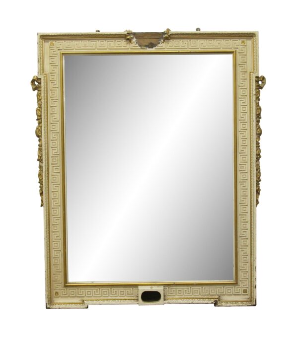 Gold and tan rectangular mirror with a Greek key frame, side ornaments, and a damaged detail at the top and bottom center.