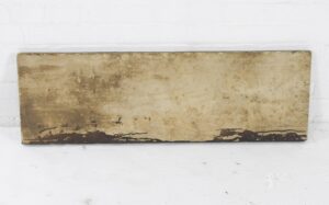 Weathered brown Arts and Crafts cast pediment with a center coat of arms motif, shown in a straight-on view.