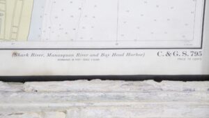 Framed nautical map showing a section labeled Shark River, Manasquan River, and Bay Head Harbor, with chart text and soundings visible in a white crackled wood frame.