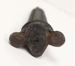 Cast iron finial shown from below, with a rounded Art Deco form and a long tapered shaft extending upward.