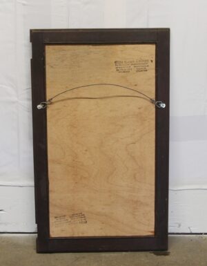 Back view of a cabinet door mirror with a dark wood frame and hanging wire attached across the rear panel.