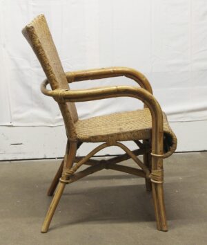 Vintage tan wicker chair with a wooden frame shown in side view.