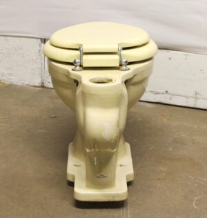 1950s light yellow toilet with matching lid and seat, shown front view without a tank.