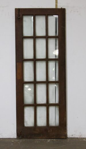 Dark wood tone French door with 15 beveled glass lites shown upright.