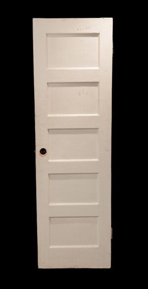 Vintage white wooden passage door with five horizontal panels and a visible hardware opening.