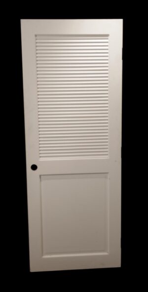 White wooden closet door with one louvered upper panel and one solid lower panel, shown front view with a round knob hole near the left edge.