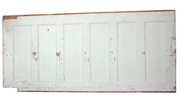 White-painted reclaimed mahogany wainscoting panel with six recessed sections and worn edges visible.