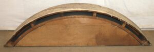 Arched door pediment with dentil molding and a dark wood tone, shown in a side view.