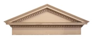 Vintage pink wooden pediment with dentil and crown molding forming a peaked top.