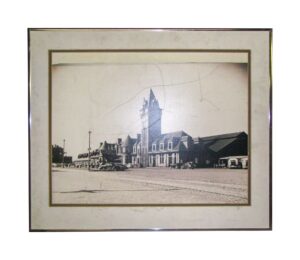 Framed black and white train station photograph with a wide matte and thin outer frame.